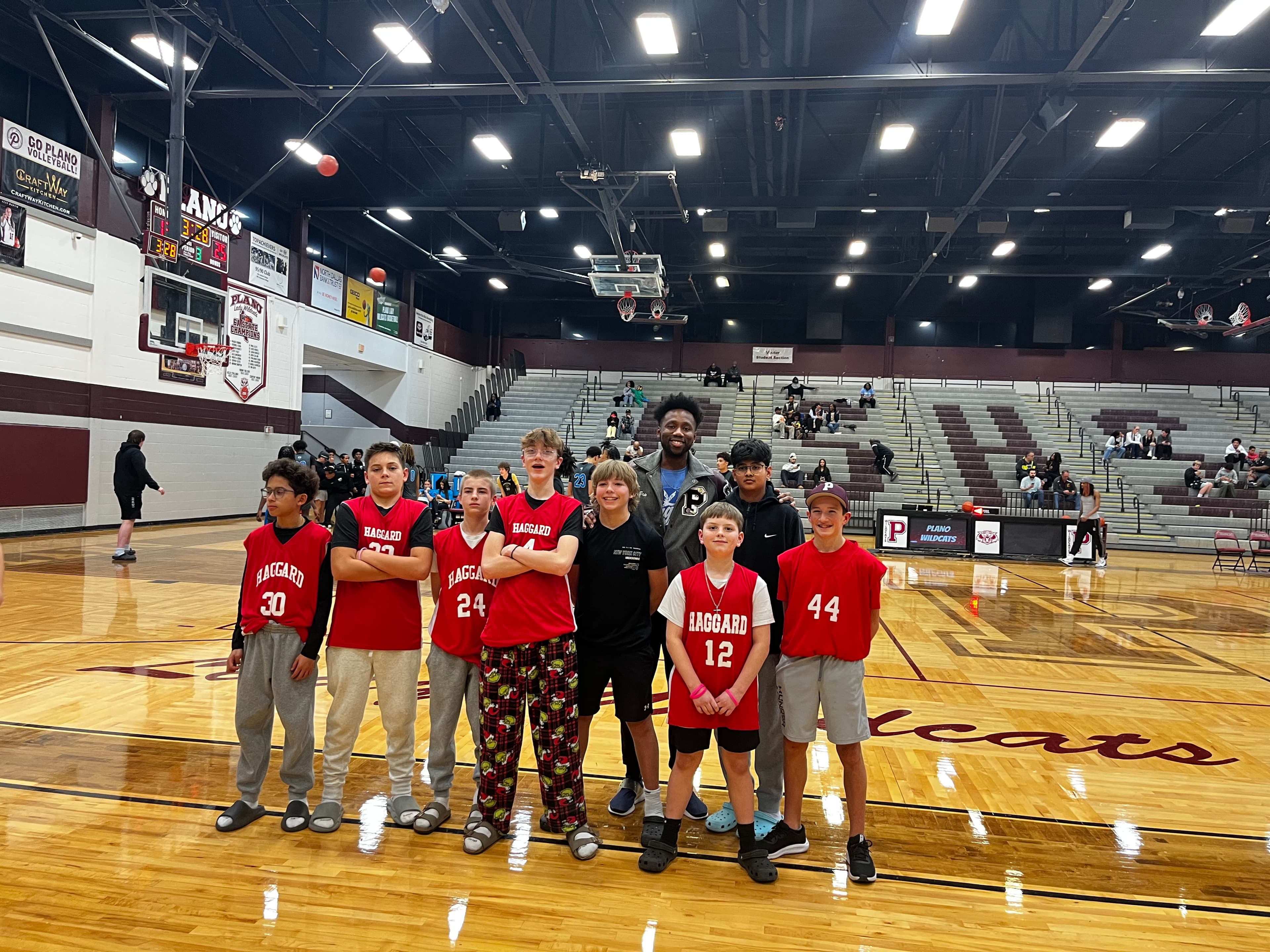 Eric Johnson with youth basketball team on court