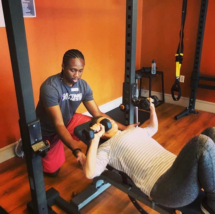 Eric Johnson training client with bench press