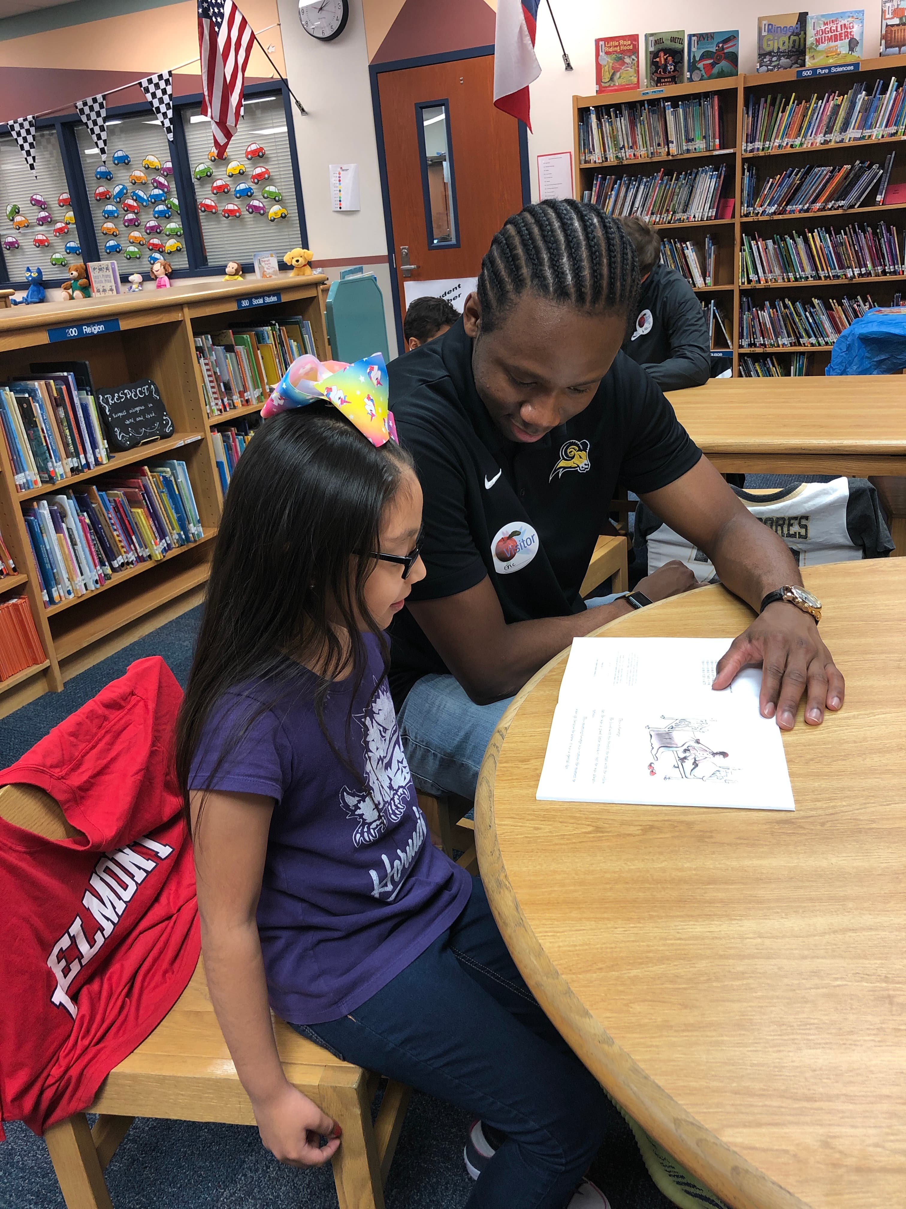 Eric Johnson mentoring student in library